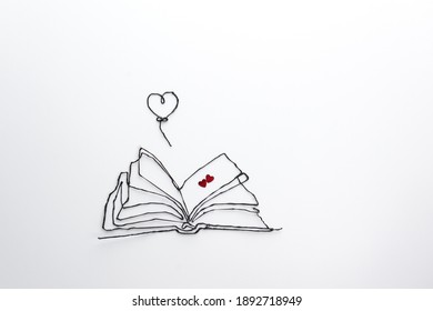 Concepto de San Valentín con libro y globo sobre fondo blanco. Fondo abstracto para tarjeta de felicitación, póster. Plano, vista superior, espacio de copia, enfoque suave.