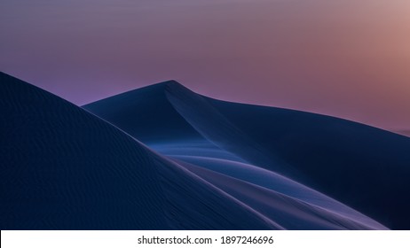 風の強い砂丘に沈むブルーアワーの夕日