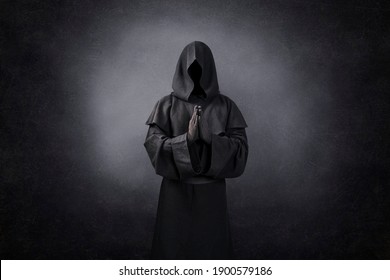 Ghostly figure praying in the dark