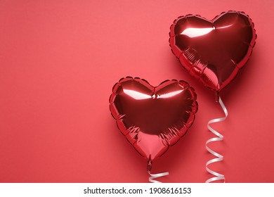 Heart shaped balloons on red background, flat lay with space for text. Valentine's Day celebration