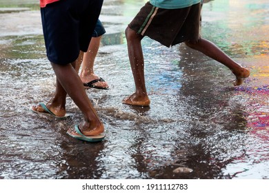 Kids playing in the rain at a vacation program in a neighbourhood in the city of Mariana, Minas Gerais, Brasil.