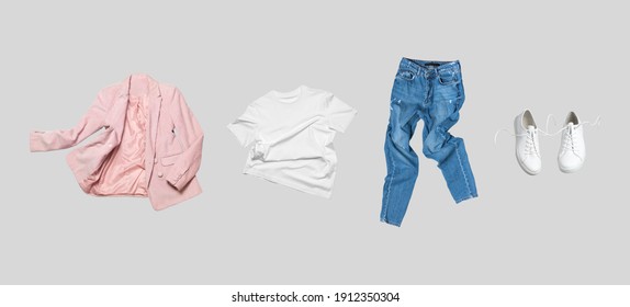 White flying cotton T-shirt, blue jeans, white leather sneakers, fashionable pink blazer jacket isolated on gray background. Clean Branding clothes. Mock up for your design. Spring Summer Clothing