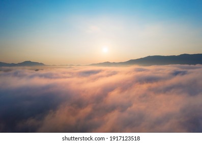 Luftbild Schön von morgendlichem Landschaftsmeer aus Wolken und Nebel fließt auf hohen Bergen.