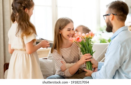 Selamat Hari Ibu! ayah dan anak-anak mengucapkan selamat kepada ibu pada hari libur dan memberi bunga