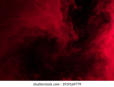 Latar belakang abstrak dari kepulan asap merah yang tercampur secara kacau pada latar belakang gelap