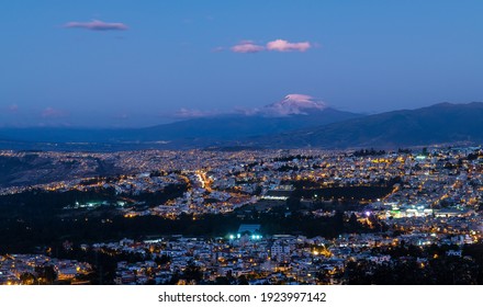 Aerial blue hour night cityscape of Quito with Cayambe volcano, Ecuador.