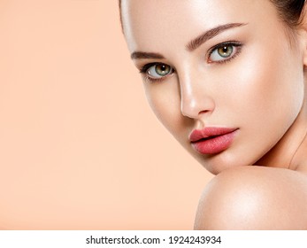 Beautiful face of young woman with health fresh skin. Portrait of beautiful  brunette woman with clean face. Closeup face of young adult woman with clean fresh skin. Skin care.