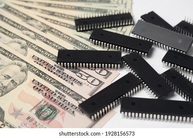 Semiconductor chips shortage and high price. Pile of computer chips and spreadof  US dollars. Concept for crisis in the industry in the United States. 