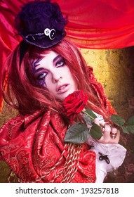 Young woman in artistic image with bright visage and with roses