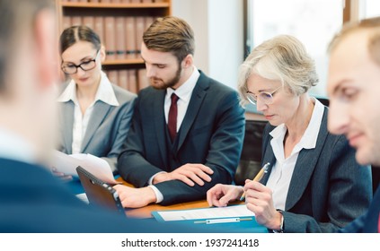 Team of partners in a law firm working diligently on a case