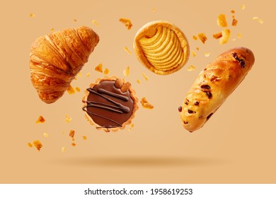 Croissant recién horneado y pasteles dulces volando en el aire. Postre dulce. Productos horneados.