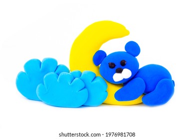 Blue bear, moon and clouds from air plasticine isolated on white background. Children's creativity