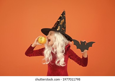 Halloween party. Small girl in black witch hat. Autumn holiday. Join celebration. Magical spell. Small witch with white hair. Wizard or magician. Halloween attributes. Little child in witch costume