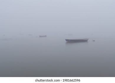 川の霧の朝。霧に消えゆく漁船。川を覆う霧。霧の中で消える手漕ぎボート。霧深い朝のゼムン海岸