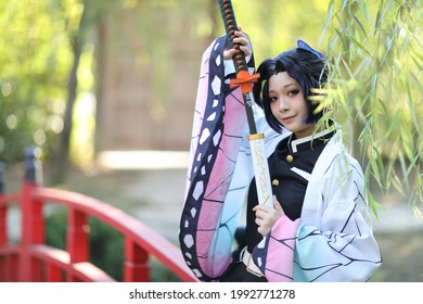 Japan anime cosplay portrait of girl with comic costume with japanese theme garden
