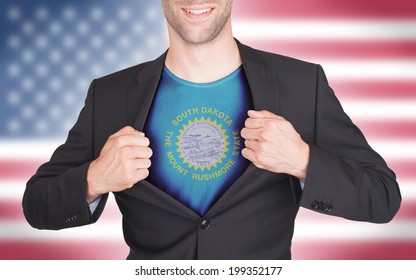 Businessman opening suit to reveal shirt with state flag (USA), South Dakota