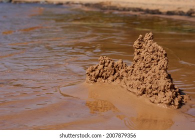 Sandburg am Strand in der Nähe des Wassers. Foto in hoher Qualität