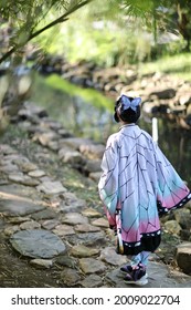 Japan anime cosplay portrait of girl with comic costume with japanese theme garden
