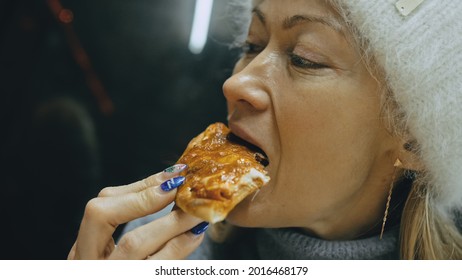 Girl eat pizza cheese four. Close up of young woman mouth greedily eating pizza and chewing in outdoor restaurant. Junk food. Pizza from open box.