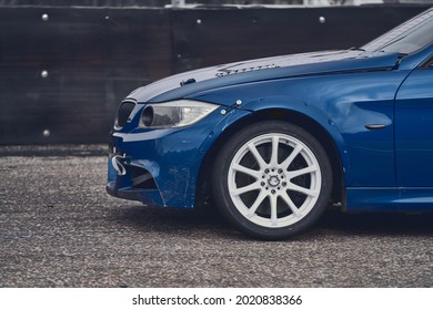Front side view of black car driving fast.