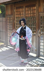 Japan anime cosplay portrait of girl with comic costume with japanese theme garden