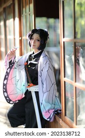 Japan anime cosplay portrait of girl with comic costume with japanese theme garden