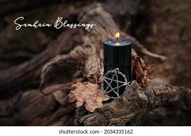 Samhain Blessings. Pentagram amulet and black candle in autumn forest. Magic esoteric witches ritual. Mysticism, divination, wicca, occultism, witchcraft concept. Samhain sabbat