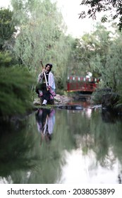 Japan anime cosplay portrait of girl with comic costume with japanese theme garden