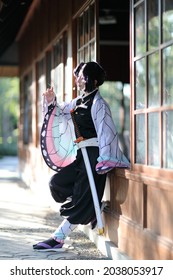 Japan anime cosplay portrait of girl with comic costume with japanese theme garden