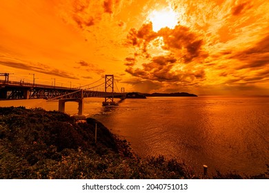 Naruto Kaikyo Ohashi bridge in the background of sunset orange color sky 