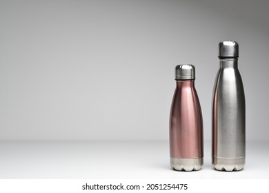 Two stainless thermos water bottle, isolated on grey background. Silver color. Steel thermo water bottle. Be plastic free. Zero waste. Copy space. Zero waste, no plastic.