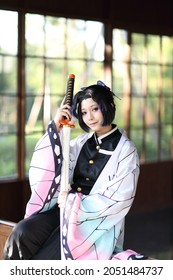 Japan anime cosplay portrait of girl with comic costume with japanese theme garden