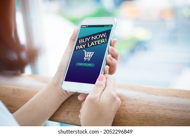 BNPL Buy now pay later online shopping concept.Hands holding mobile phone