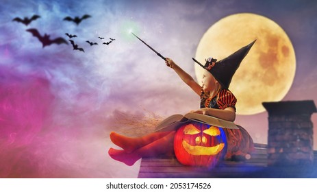 little witch outdoors with the magic wand - helloween concept