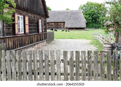 Sierpc, Poland - June 11, 2020: Old wooden house in the Polish countryside. Historic buildings with wooden shutters, spring scenery. Open-air museum of the Mazovian Countryside.
