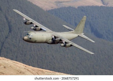Lockheed C-130 Hercules military transport plane flying low level in the united kingdom