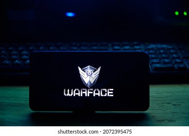 Kostanay, Kazakhstan, November 02, 2021. Mobile phone with screensaver logo popular Warface game