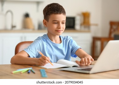 Little boy studying online at home