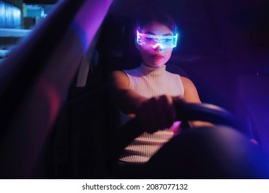 Fashion cyberpunk girl drive a supercar. Asian woman  with future digital glasses,future technology concept