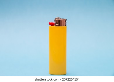 Yellow cigarette lighter centered and isolated.