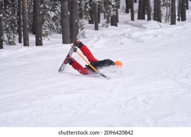 The fall of a snowboarder with a t-bar lift.  He does not let go of the crossbar in violation of safety rules. Copy space.                               
