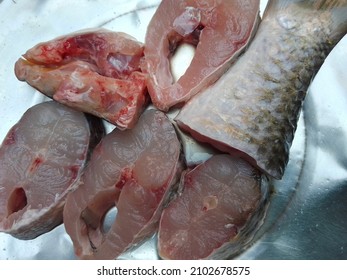 Cut pieces of rohu fish also called rui fish in south Asia resting in a plate.
