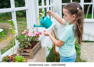 Concepto de jardinería al aire libre. Linda chica caucásica regando plantas que crecen en macetas. Niño cuidando y aplicando agua al suelo de la regadera. Actividades de primavera para cultivar plantas con niños