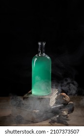  Bottle of magic potion, witchery herbs and books of spells or recipes on the wizard's desk.