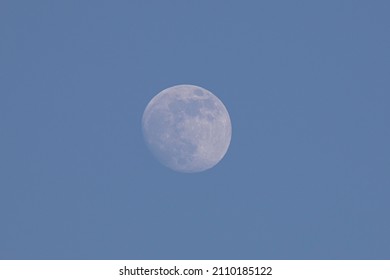 Full moon before sunset in the winter sky