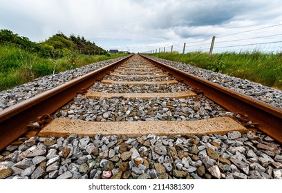 Railway tracks seem to point towards infinity. Linear railroad points toward a faraway location in a straight direction conveying purpose concept, personal growth or path and destiny illustration