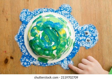 Bastelspielzeug. Wir spielen zu Hause ein Märchen. Kindheitsfantasie. Workshop für Kunst und Kreativität im Kindergarten. Malen, Färben und Kleben. Grüne Schildkröte aus Abfall. sortieren, recyceln, wiederverwenden.
