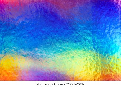Rainbow colorful metallic holographic iridescent foil background texture