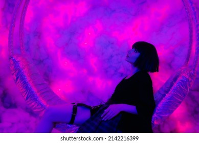 Cyberpunk and neon, young girl. Cyberpunk girl with short black hair. Futuristic neon style. Stylish young woman with asian anime hairstyle