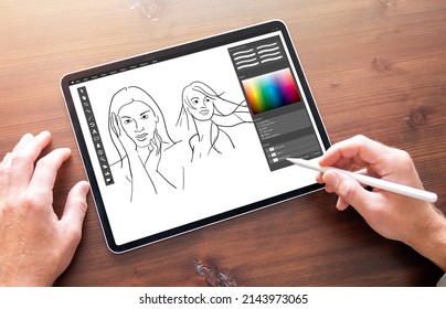 Person drawing sketches on digital tablet